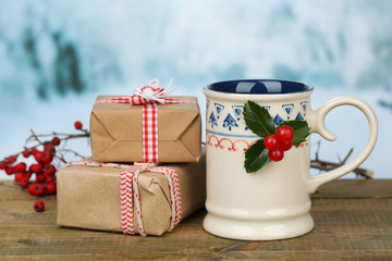 Christmas composition with cup of hot drink, on wooden table