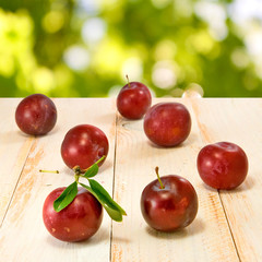 plums on green background