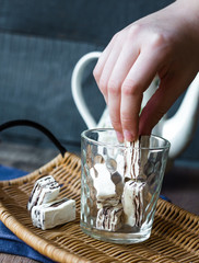 eating the nougat candy in a glass and kettle, hands