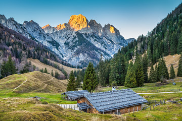 Mountain landscape in the Alps with chalets at sunset