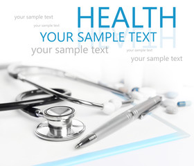 Stethoscope and other things on light background