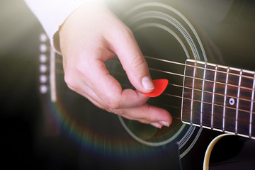 Acoustic guitar in female hands, close-up