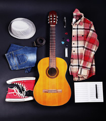 Fototapeta premium Musical equipment, clothes and footwear on dark background