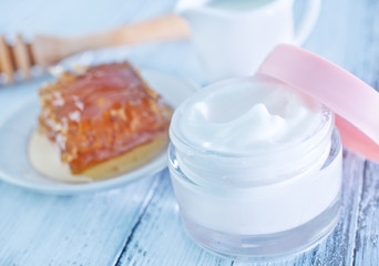 body lotion in glass bank and on a table