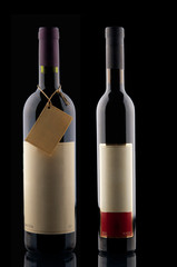 Two wine bottles on black background
