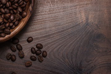 coffee beans and wooden bowl on brown table