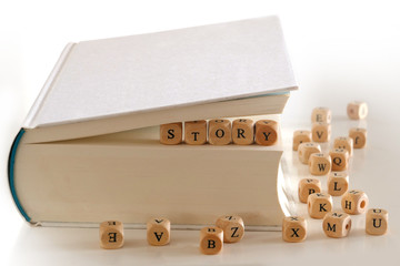 story - writing message of wooden letter blocks in a white book