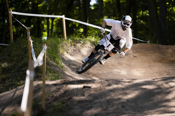 Mountainbiker rides on track in forest
