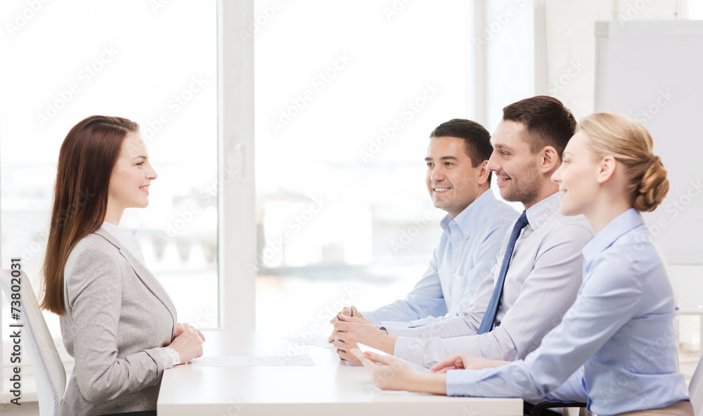 Sticker smiling businesswoman at interview in office