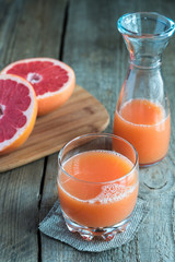 Grapefruit juice on the wooden table