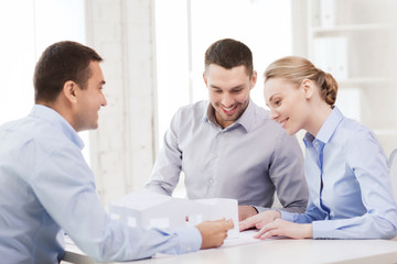 couple looking at model of their house at office