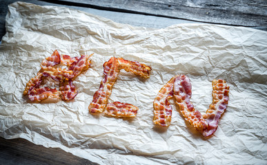 Fried bacon strips with fresh rosemary