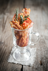 Fried bacon strips with fresh rosemary