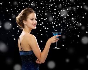 smiling woman holding cocktail