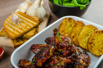Sticky chicken wings with garlic panini bread