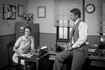 1950s businessman and secretary working in the office