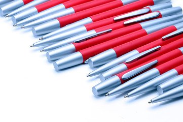 Silver-red metal pens isolated on white background.