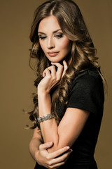 Beautiful young woman with long brown hair. Pretty model poses a