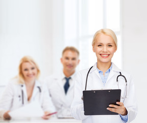 smiling female doctor with clipboard