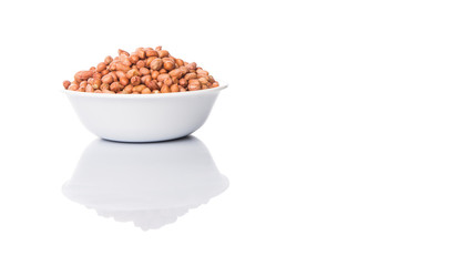 Peanut or ground nut in white bowl over white background