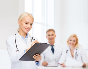 smiling female doctor with clipboard