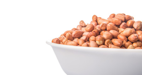 Peanut or ground nut in white bowl over white background