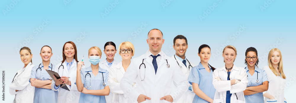 Wall mural group of smiling doctors with clipboard