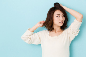 Fototapeta premium attractive asian woman on blue background