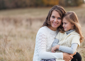 Naklejka premium Young mother and her toddler girl have fun