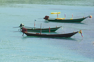 Three longtail boats on the water - traditional Thaialand