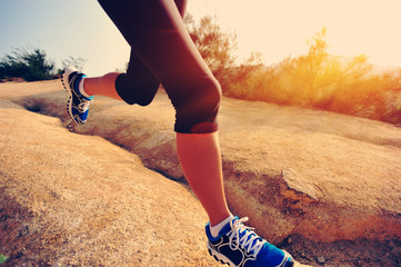 woman runner athlete running at mountain trail