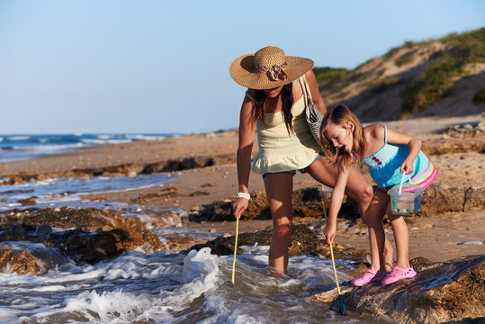 mother daughter fishing beach