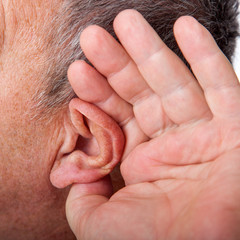 Man holding ear to listen