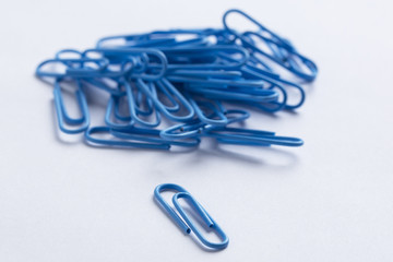 blue paperclips on a white surface