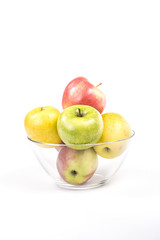 multicolored apples in a transparent bowl