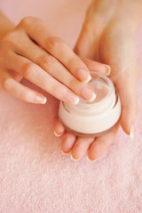 Beautiful woman hands with cream