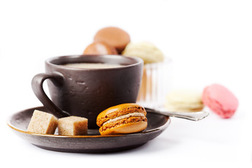 Cup of coffee and macaroons on white background, toned