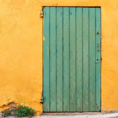 Green door on yellow wall in Provence