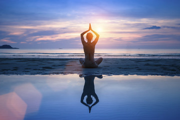 Yoga on the sea beach, meditation.