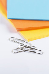 paperclips and coulerfull cardboard on a white table