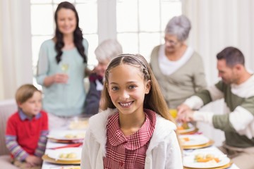Portrait of girl smiling at camera in front of her family