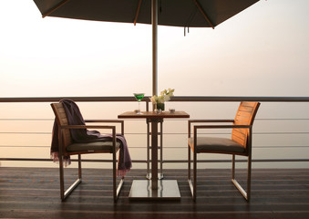 Luxury chairs against sunset view - 73819635
