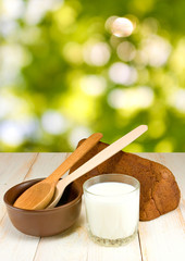 bread and a glass of milk on a green background