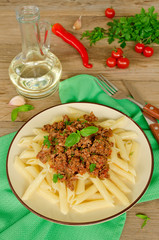 Pasta with Bolognese ragout on a wooden table