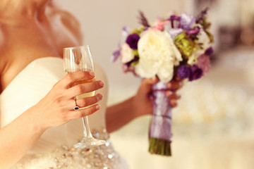 Bride wedding holding glasses of champagne flowers bouquet