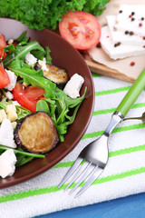 Eggplant salad with tomatoes, arugula and feta cheese,