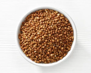 Deurstickers bowl of buckwheat grains © Mara Zemgaliete