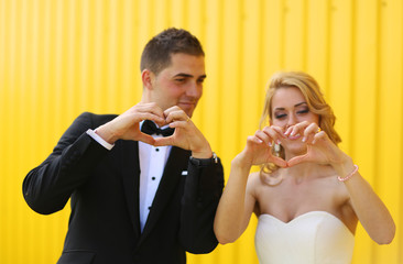 Bride and groom on a yellow background