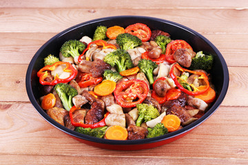 Braised wild mushrooms with vegetables and spices in pan