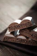 Tasty porous chocolate on wooden table